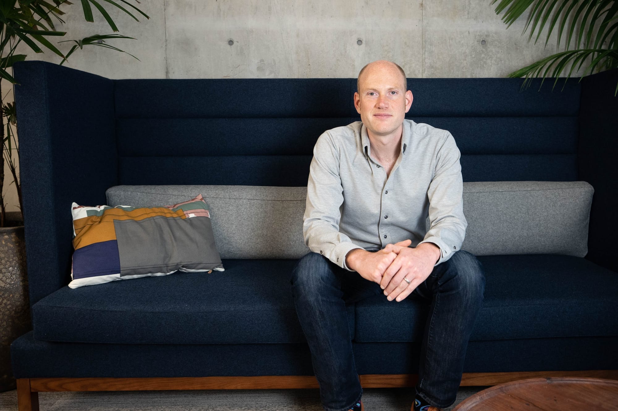 Photo of Will Larson sitting on a blue coach