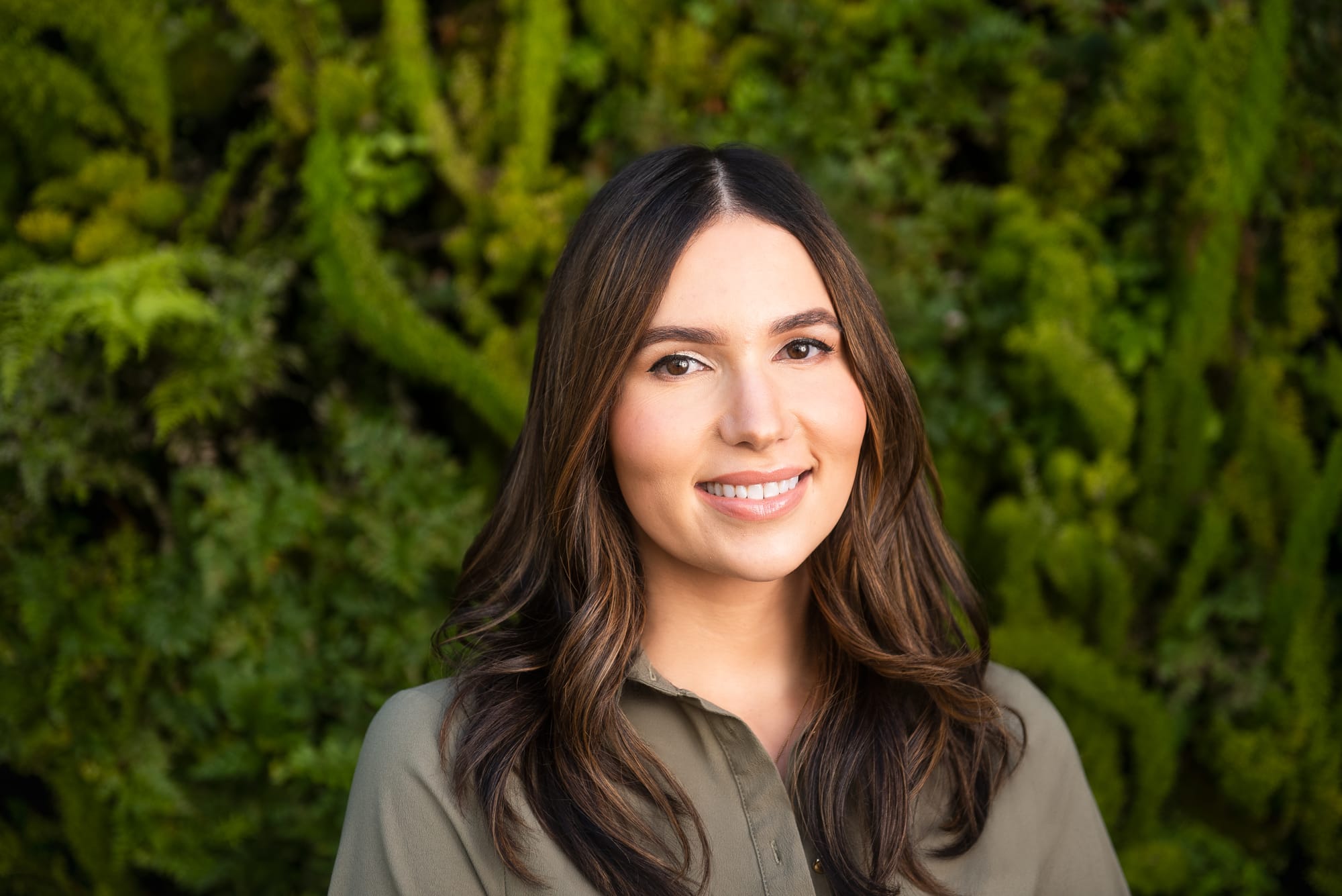 Photo of Cristina Cordova, against green plant background