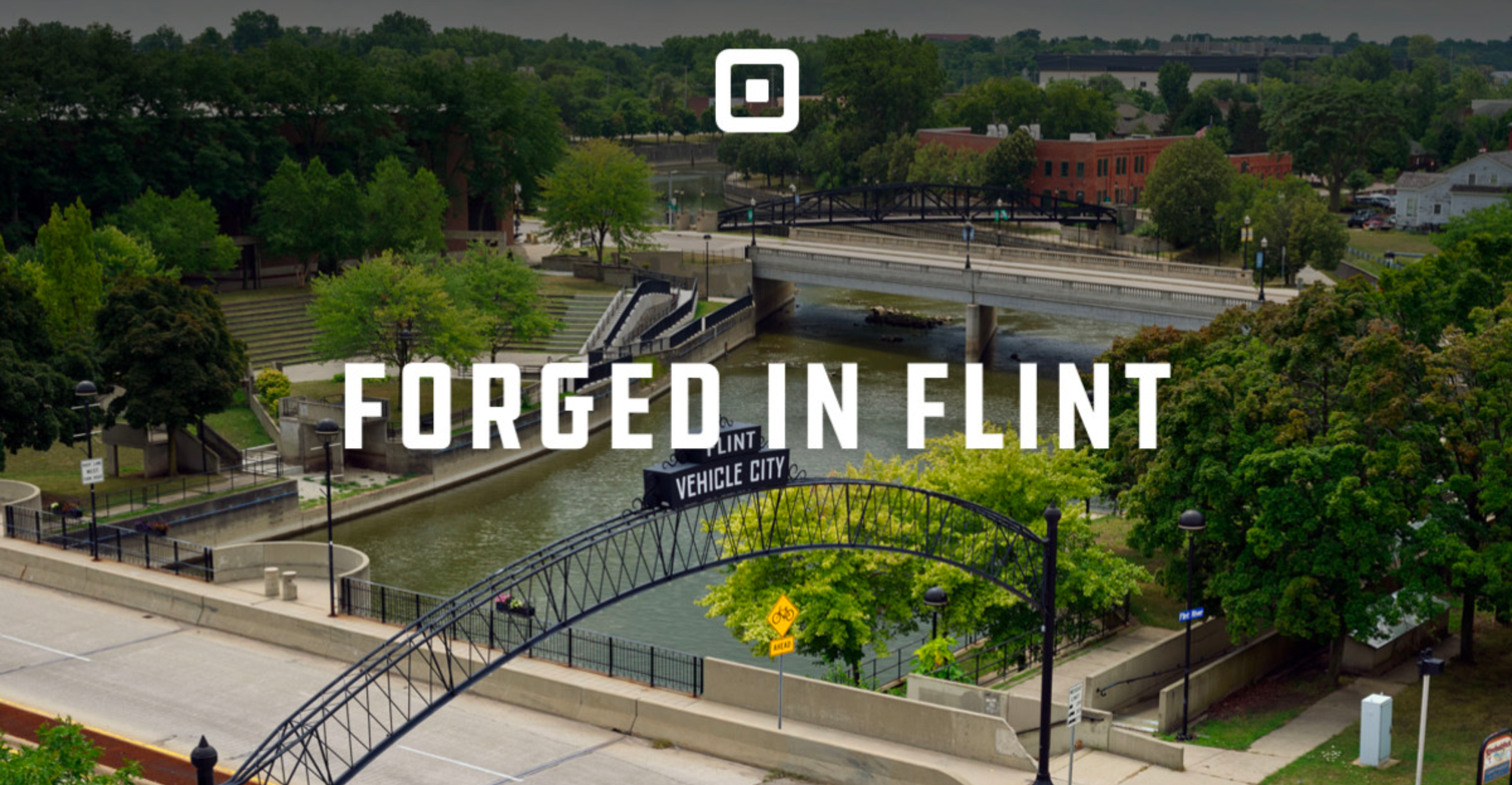 A Square ad that reads "Forged in Flint" on top of a photo of the city of Flint